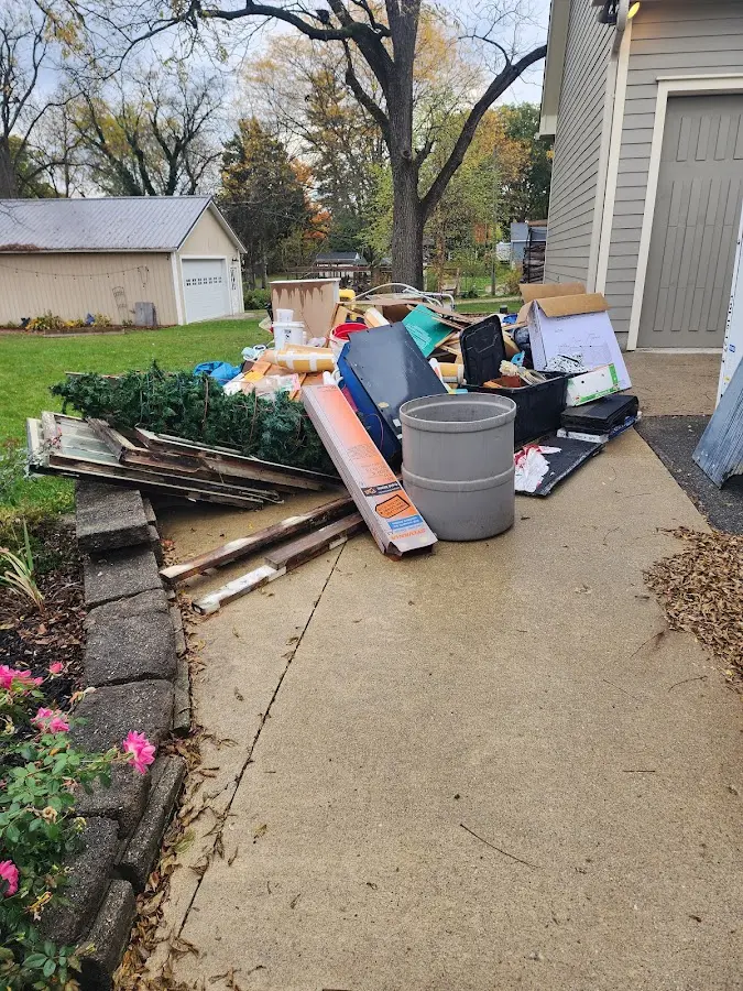 Dumpster being loaded with debris for Demolition Dumpster Rental in Burlington